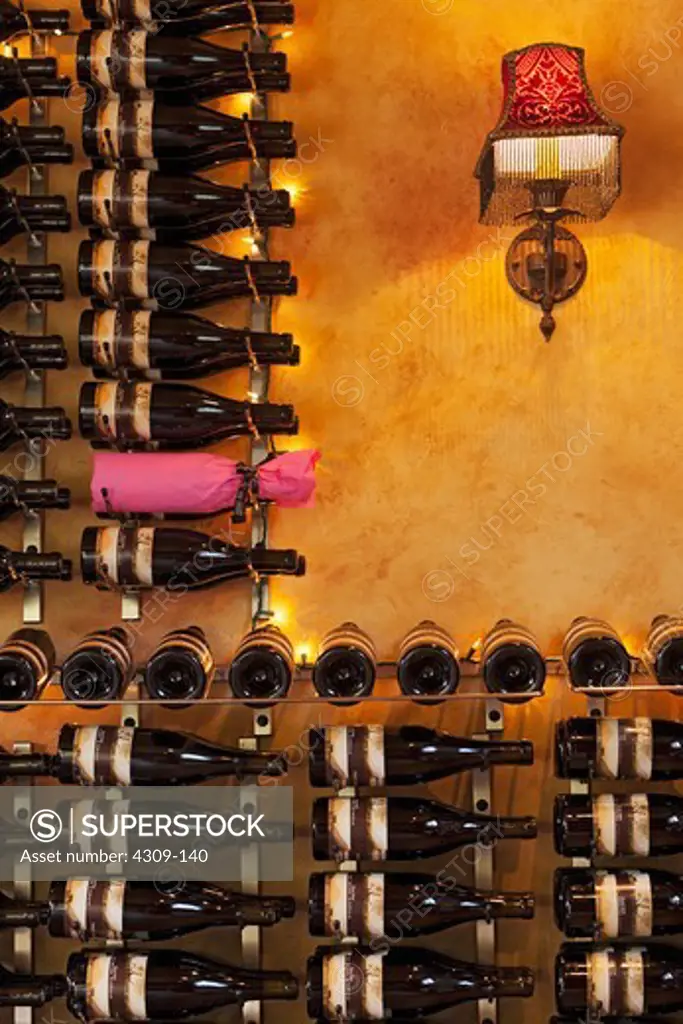 Many bottles of wine on racks.