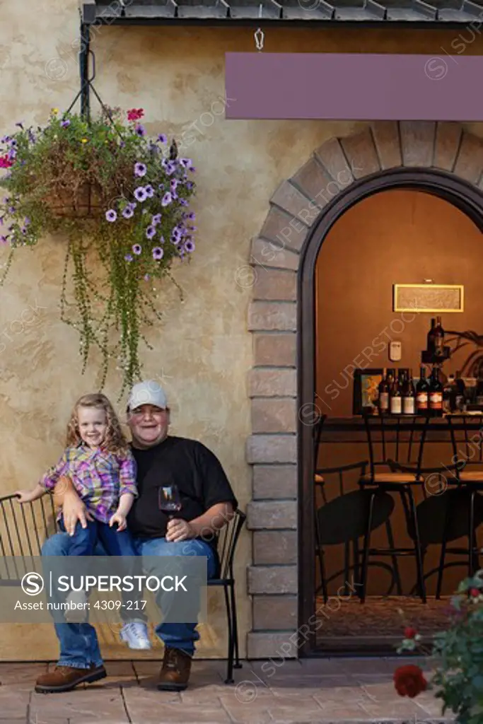 Winemaker Andrew Martinez and his daughter sit outside his tasting room in Prosser, Washington.