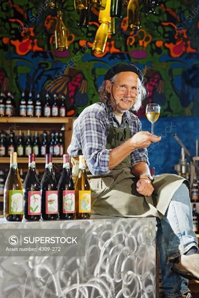 Owner and winemaker Robin Dobson with a glass of his organic, sulfite free, naturally fermented wine, photographed in his tasting room in the Columbia River Gorge AVA near Lyle, Washington.