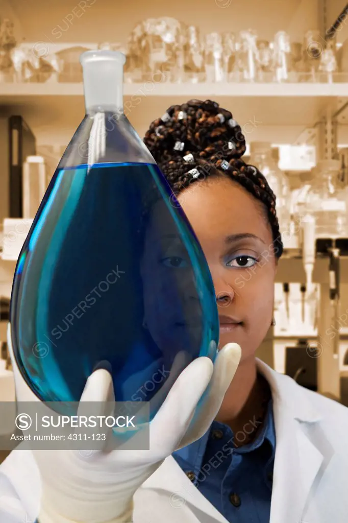 A Scientist Looks Through a Flask