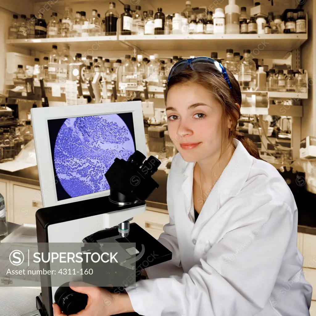 A Scientist Looks Up From Her Microscope