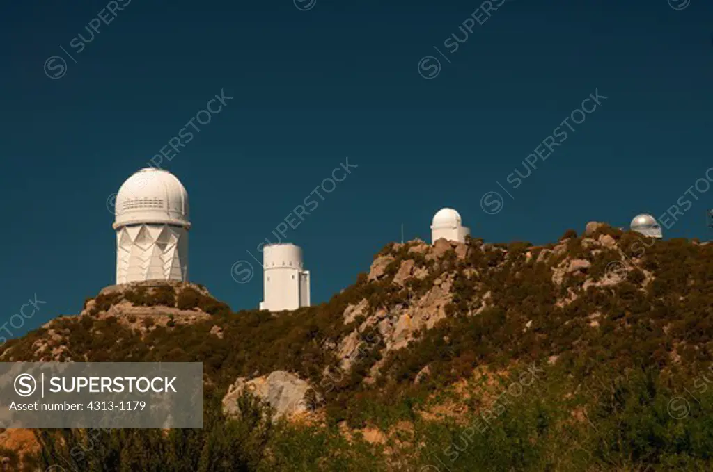 The 4-meter Mayall (L), 2.3-meter Bok Reflector, 0.9-meter Spacewatch and 0.6-meter LOTIS telescope domes are seen atop Kitt Peak National Observatory, Arizona.