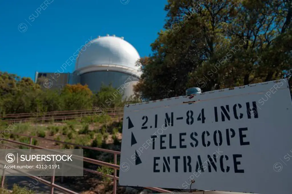 A sign points to the 2.1-meter telescope dome at Kitt Peak National Observatory, Arizona
