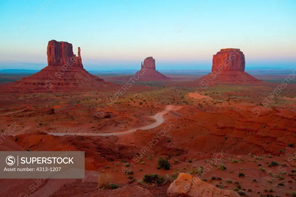 The buttes known as the Mittens (west mitten at left, east mitten at center) are seen after sunset in Monument Valley Tribal Park, on the Utah-Arizona border