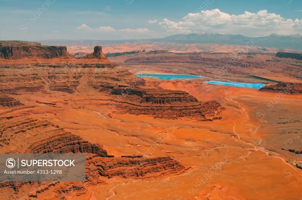 Bright blue solar evaporation ponds are seen from Dead Horse Point State Park in the Utah Desert between Canyonlands National Park and Moab. The ponds are used for the mining of muriate potash at Cane Creek Potash Mine, also known as the Moab or Intrepid Potash Mine.