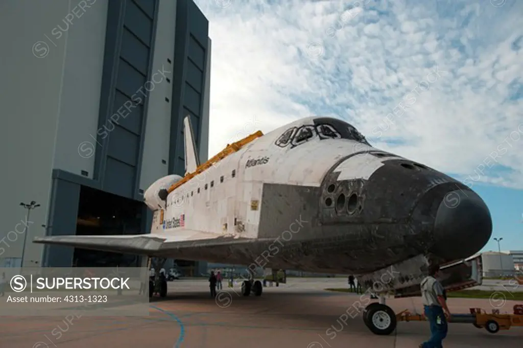 The Space Shuttle Atlantis is seen as it is moved between the Vehicle Assembly Building and Orbiter Processing Facility to undergo final preparations for its transfer to the Kennedy Space Center Visitors Complex museum following its retirement at the end of the shuttle program.