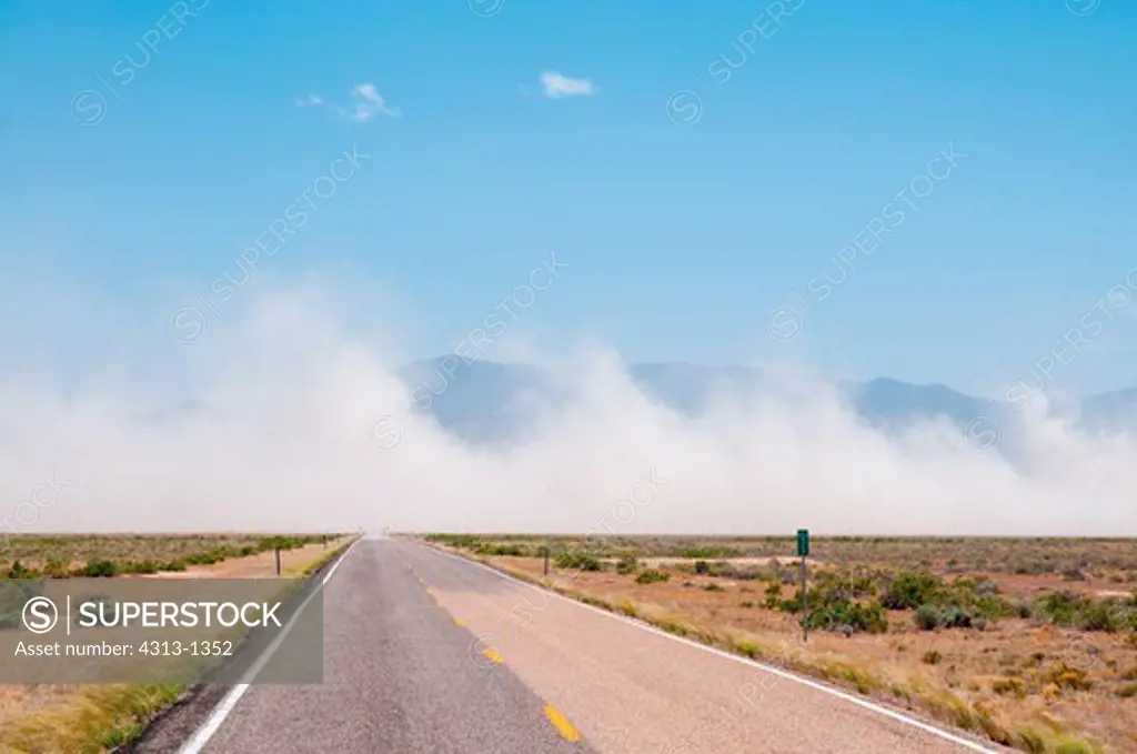 A dust storm is seen blowing across a remote highway in Utah