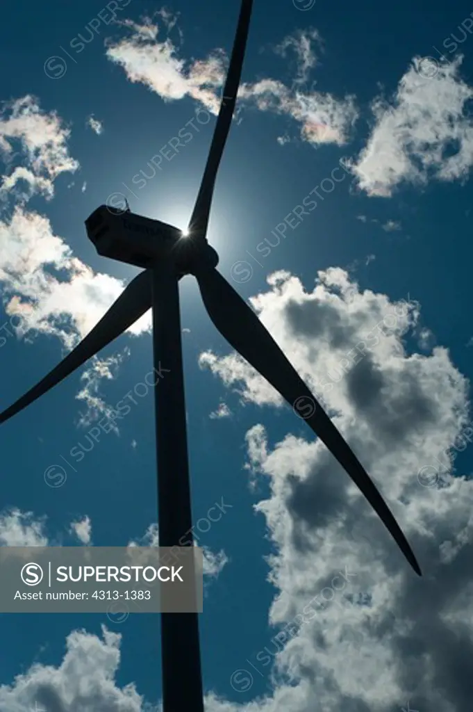 Canada, Alberta, Windmill's silhouette against blue sky with clouds