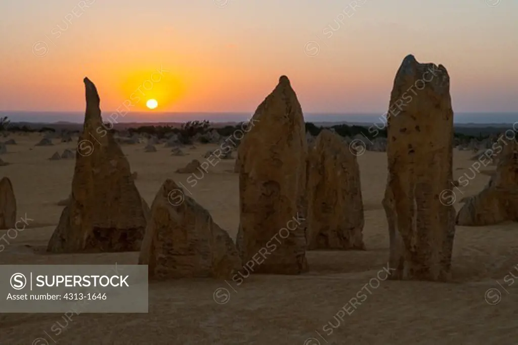 Australia, Western Australia, Pinnacles Desert in Nambung National Park at sunset with Indian Ocean in background