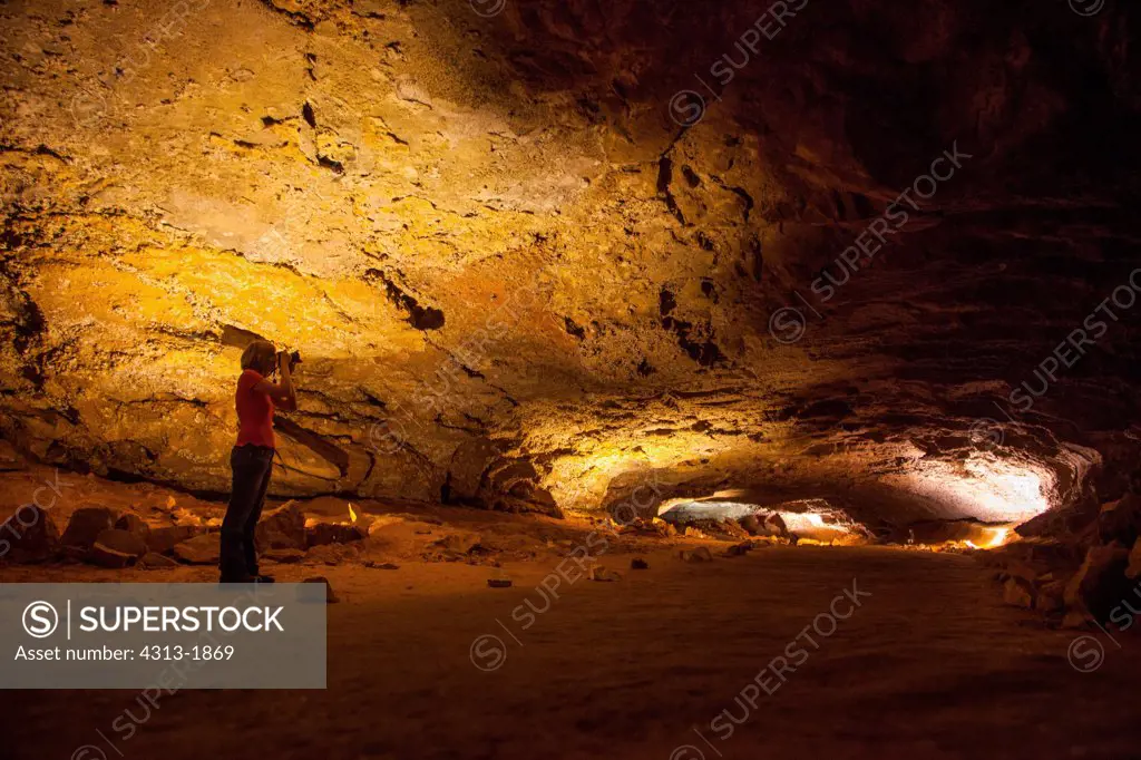 Hiker taking a photo in the Grand Avenue section of Mammoth Cave National Park, Kentucky, USA