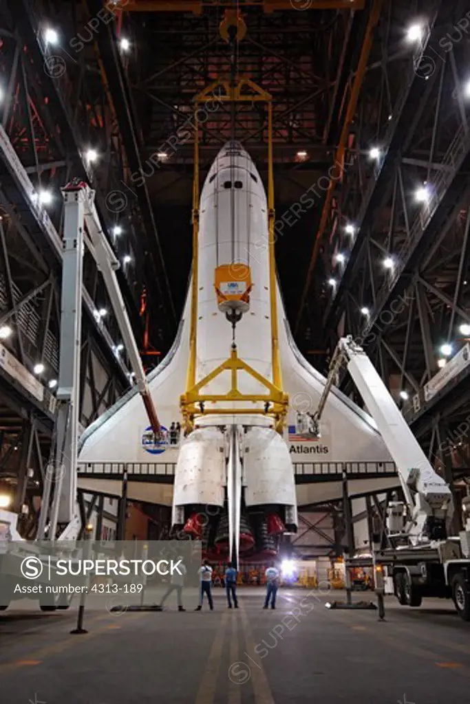 In this rare photo opportunity, the Shuttle Atlantis hangs from the ceiling in this fisheye view inside the Vehicle Assembly Building after being rotated vertically, in preparation for attachment to its rocket boosters for its final mission, STS-132.