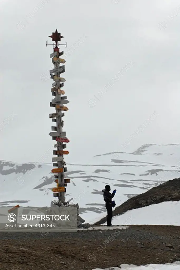 A signpost at Chile's Frei research base on King George Island, Antarctica, showing miles to distant cities in the north.