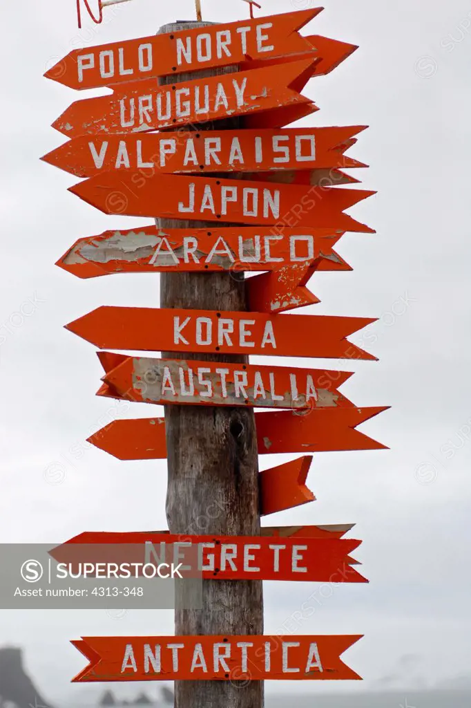A Spanish signpost at Chile's Frei research base on King George Island, Antarctica, showing miles to distant cities in the north.