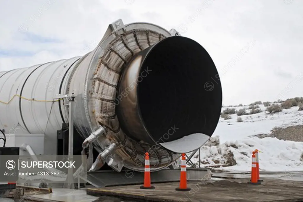 The booster nozzle, seen following the final test firing of a space shuttle solid rocket booster at the ATK test site near Promontory, Utah. The white substance inside the nozzle is frozen carbon dioxide which was used to extinguish the booster following the test.