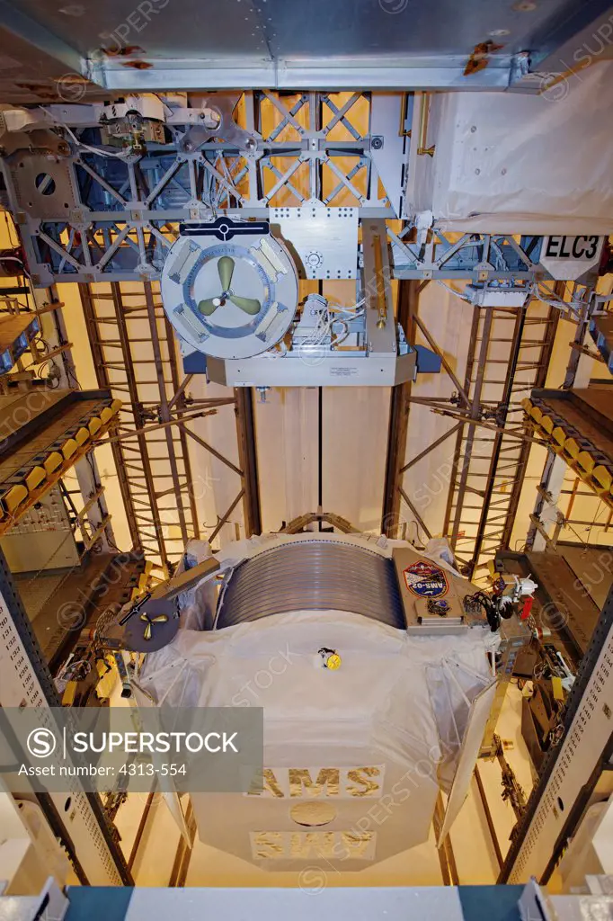 The Alpha Magnetic Spectrometer payload for STS-134, a $2 billion particle physics  science experiment that is mounted to the side of the International Space Station, to look for dark energy and dark matter.