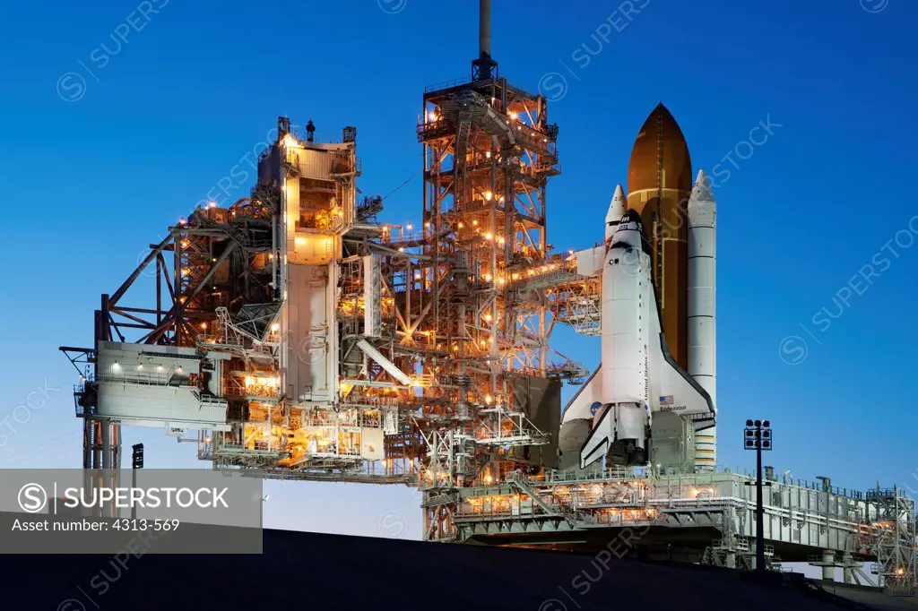 Space shuttle Endeavour stands atop Pad 39A after sunset, following a launch scrub for STS-134.
