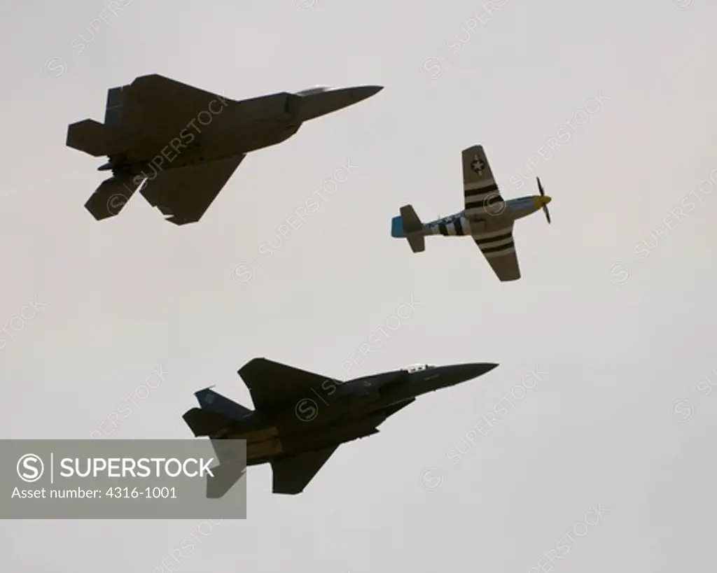 F-22 Raptor, P-51D Mustang, and an F-15E Strike Eagle in Tight Formation
