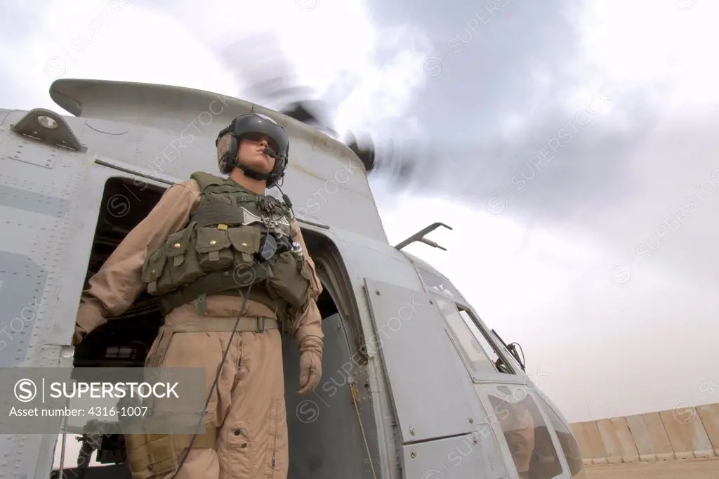 Crew Chief of a US Marine Corps CH-46 Sea Knight Helicopter Scans The Distance Before a Mission to Baghdad