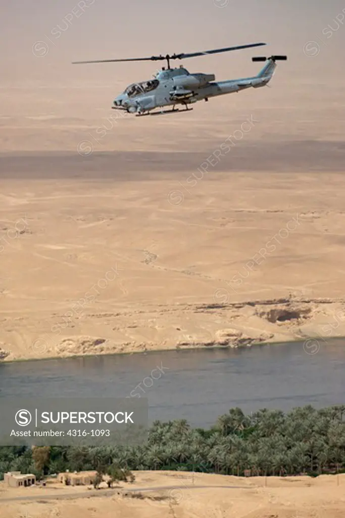 A US Marine Corps AH-1W Super Cobra Flies Above the Euphrates River During a Close Air Support Mission in Iraq's Al Anbar Province