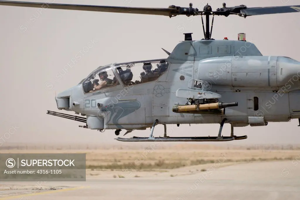A US Marine Corps AH-1W Attack Helicopter Hovers After Refueling at Al Asad Air Base in the Al Anbar Province of Iraq