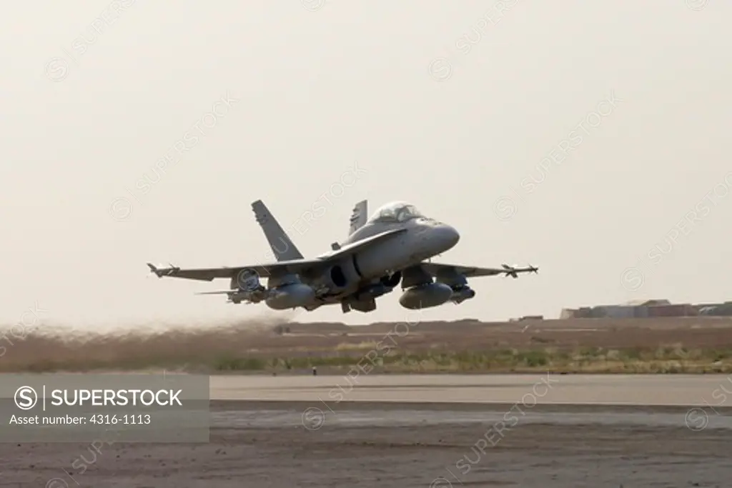 A US Marine Corps F/A-18D Hornet Launches from Al Asad Air Base in the Al Anbar Province of Iraq on a Close Air Support Mission