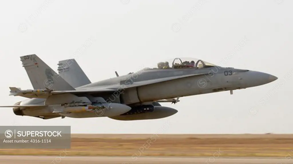 A US Marine Corps F/A-18D Roars Just Feet Above a Runway at Over 300 Knots During an Unrestricted Takeoff from Al Asad Air Base in the Al Anbar Province of Iraq At the Start of a Close Air Support Mission
