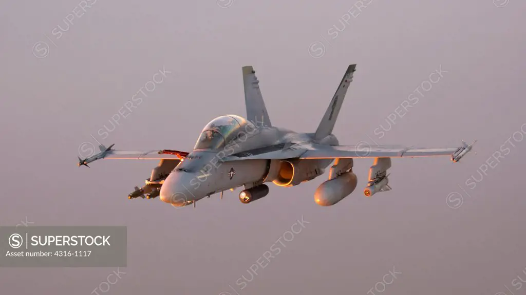 Air to Air View of a US Marine Corps F/A-18D Hornet Miles Above the Al Anbar Province of Iraq at Sunset During a Combat Operation