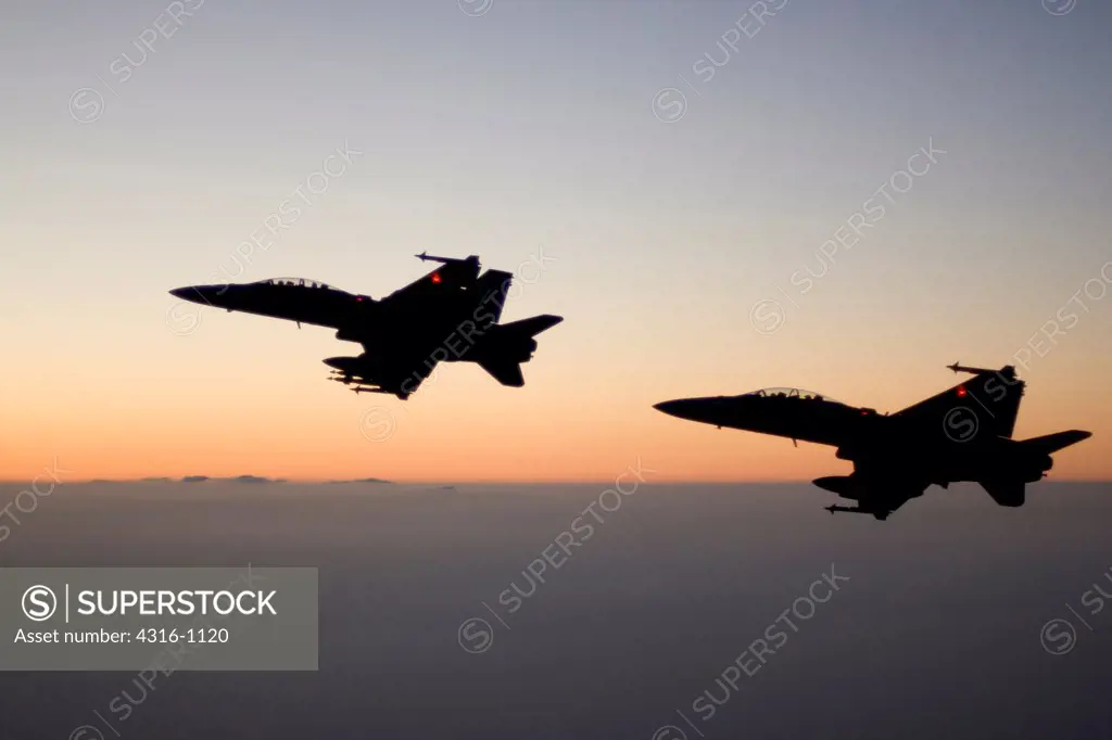Air to Air View of Two US Marine Corps F/A-18D Hornets Miles Above the Al Anbar Province of Iraq at Sunset During a Close Air Support Mission