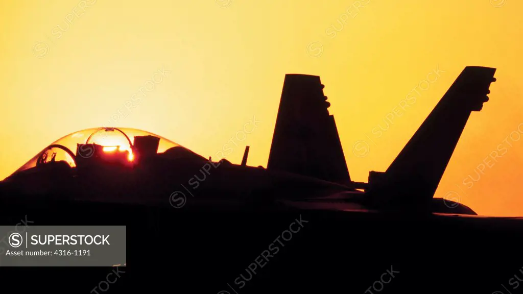 The Setting Sun Silhouettes a US Marine F/A - 18D Hornet at Al Asad Air Base in the Anbar Province of Iraq