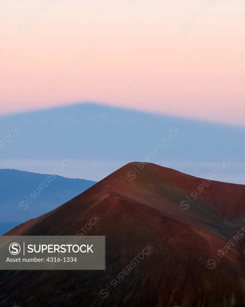 Dawn Light Casts a Shadow of Mauna Kea, Hawaii's Highest Point, Across a Deck of Clouds Over the Pacific Ocean