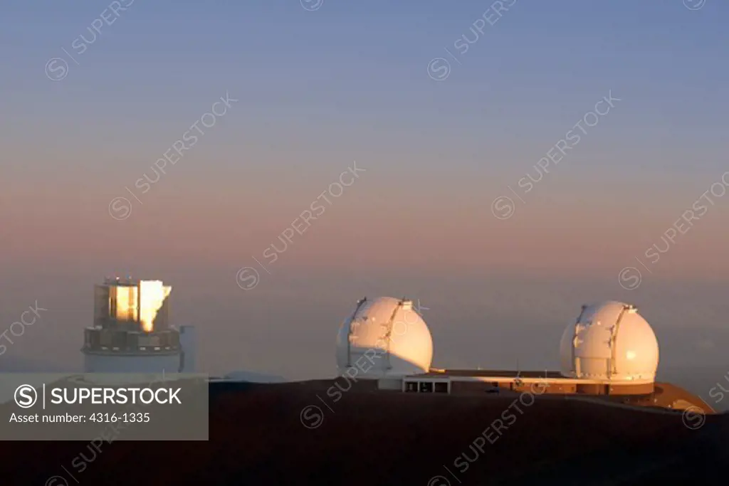 The Subaru Telescope and the Twin Telescopes of the W. M. Keck Observatory Above the Clouds at the Summit of Hawaii's Mauna Kea