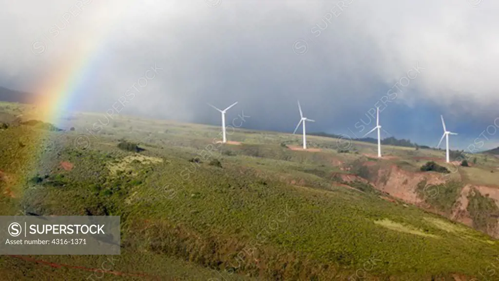 Rainbow and Clouds Frame Wind Turbines of the Kaheawa Wind Energy Project, on the West Maui Mountains of the Hawaiian Island of Maui