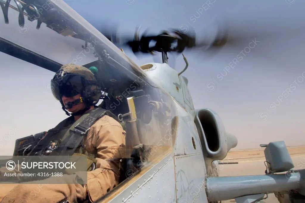 View of a US Marine Corps Aviator in His AH-1W Super Cobra While It Refuels at Al Asad Air Base in Iraq's Al Anbar Province