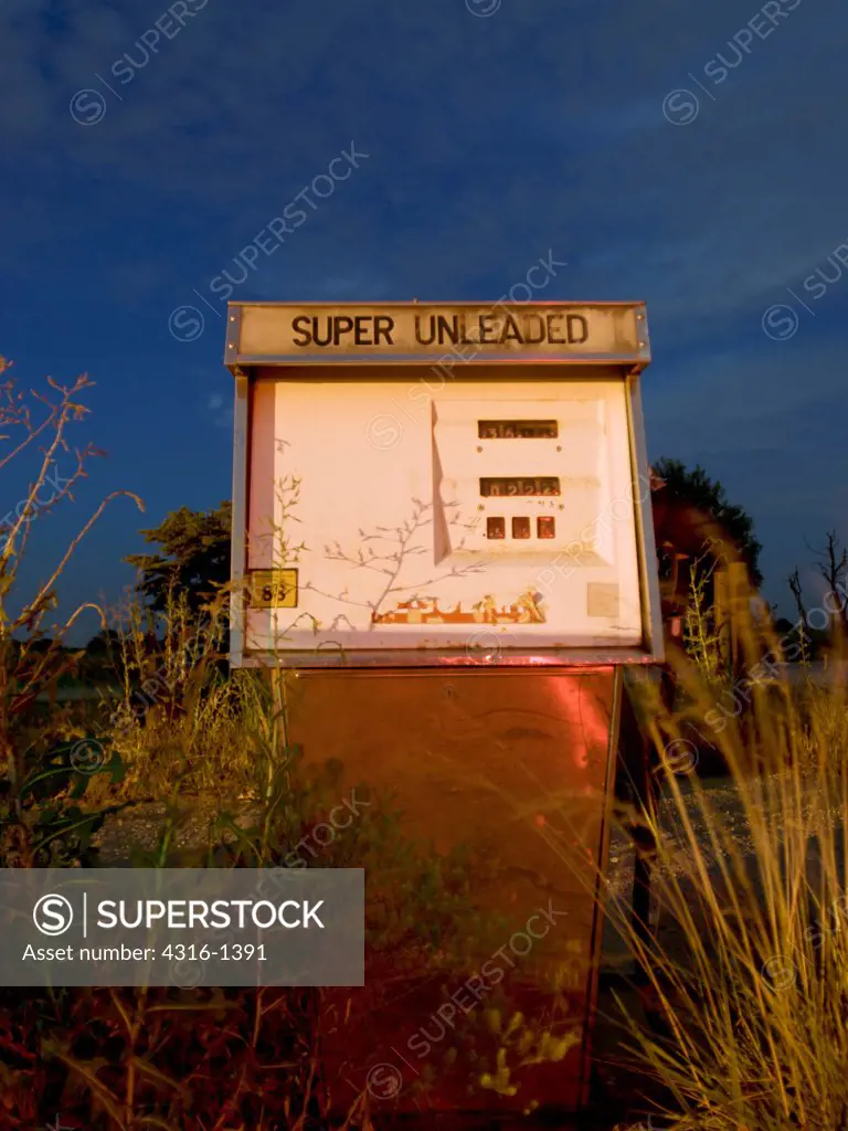 Sunset View of An Abandoned and Overgrown Gasoline Pump