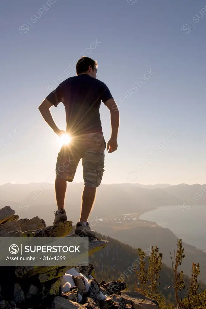 A Hiker Gazes Across Lake Tahoe at Sunset From a Mountaintop