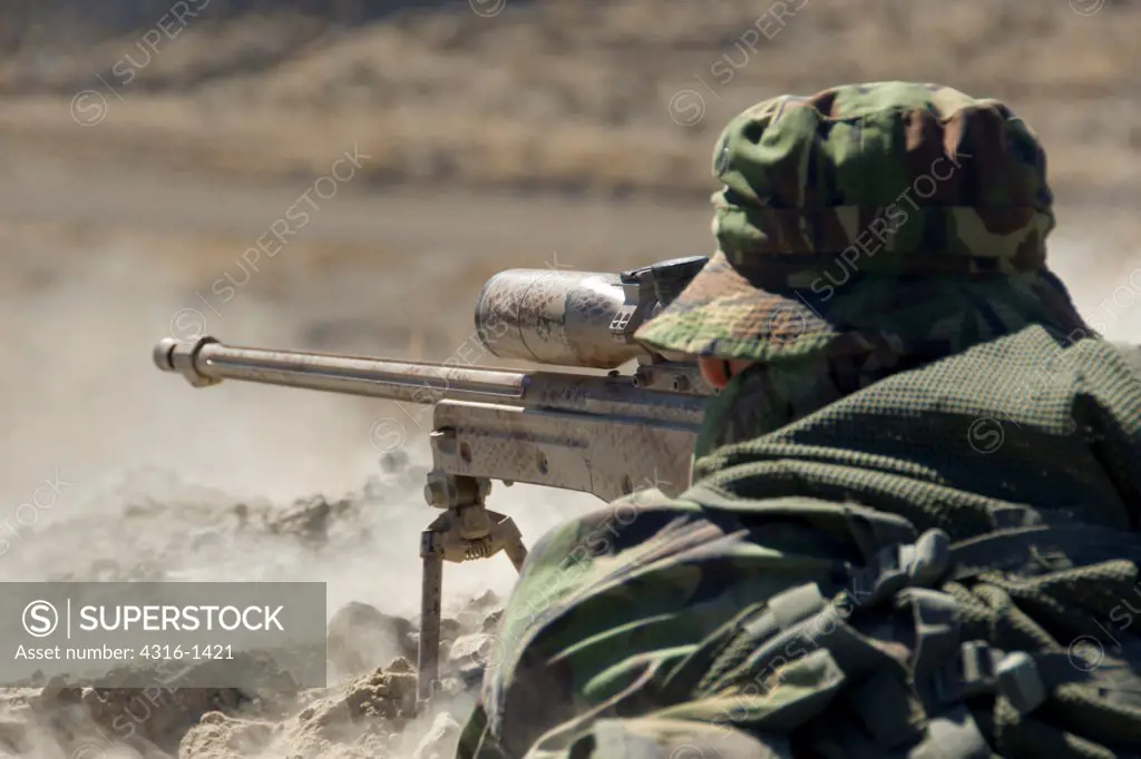 A British Royal Marine Commando Sniper Fires A High Power Rifle