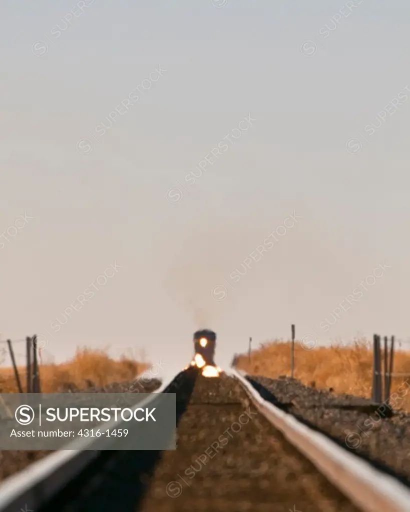 Inferior Mirage Distorts Distant, Approaching Freight Train in West Texas