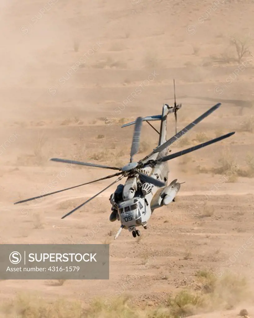 A U.S. Marine Corps CH-53E Makes a Dusty Liftoff from a Desert Landing Zone