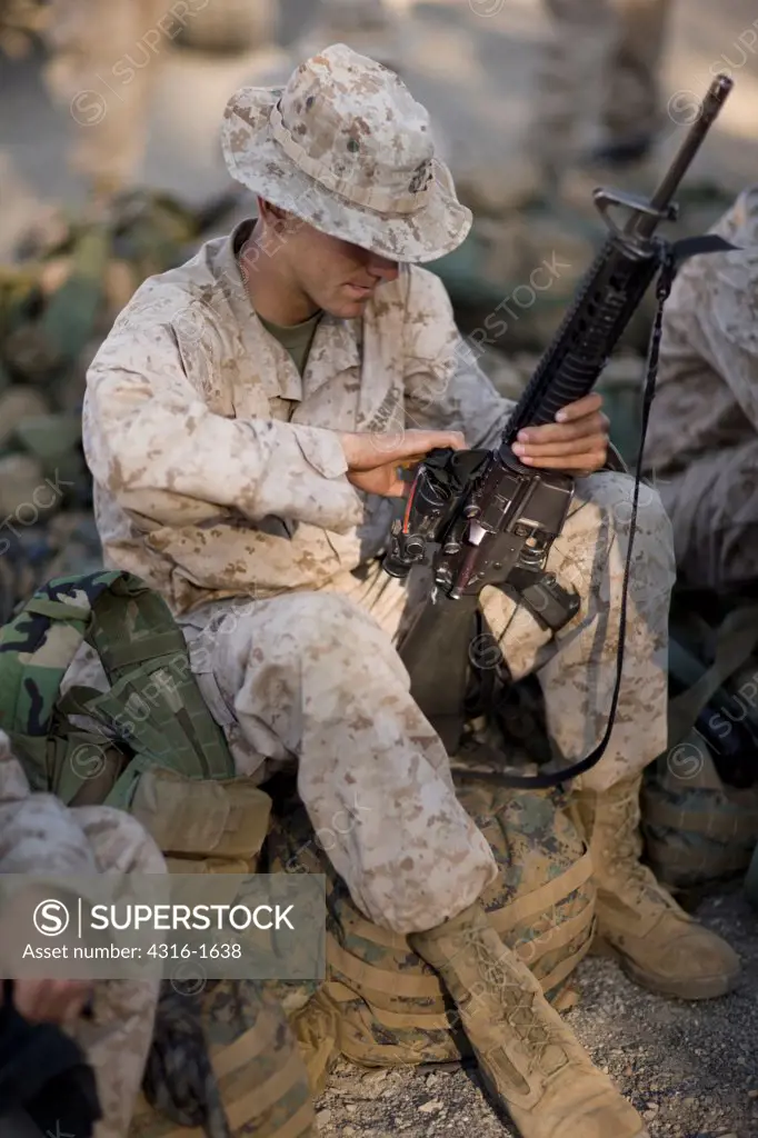 U.S. Marine Maintains His M16 Service Rifle