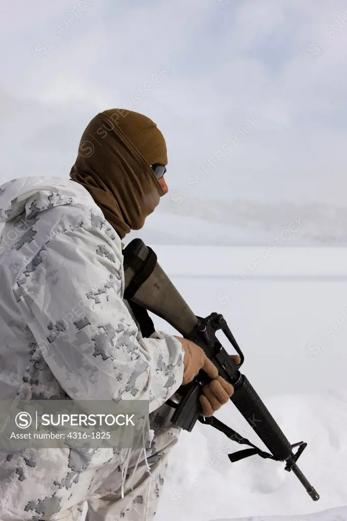 U.S. Marine With Winter Camouflage Overwhites Holds an M16 During Mountain Warfare Training