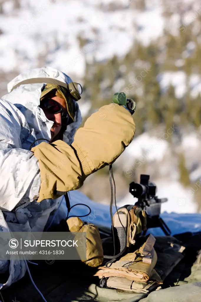 A U.S. Marine Scout Sniper Measures Wind Velocity with a Handheld Anemometer