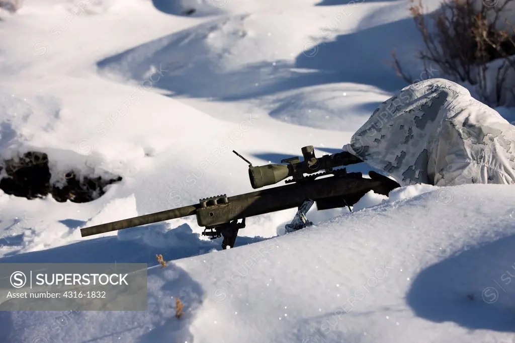 U.S. Marine Scout Sniper Aims an M40A3 Sniper Rifle While Camouflaged in the Snow