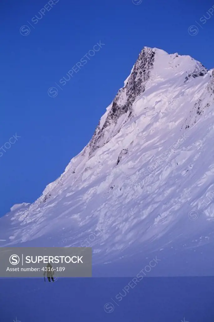 The Vertical North Face of King Peak Dwarfs a Visiting Climber