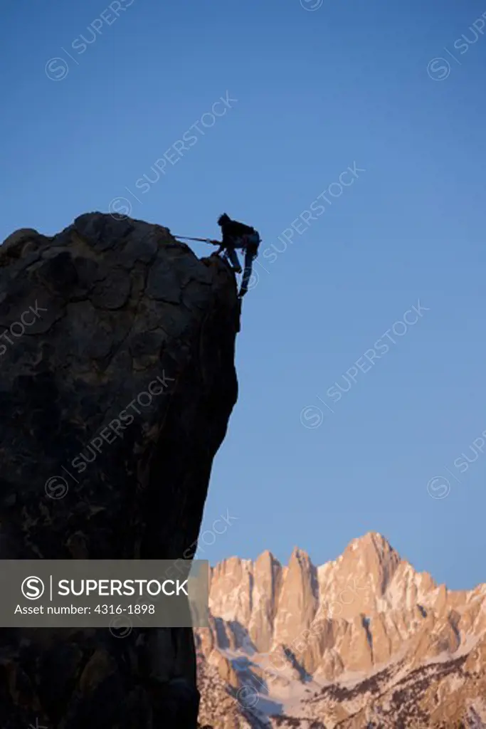 Climber Prepares to Rappel Down an Overhanging Face