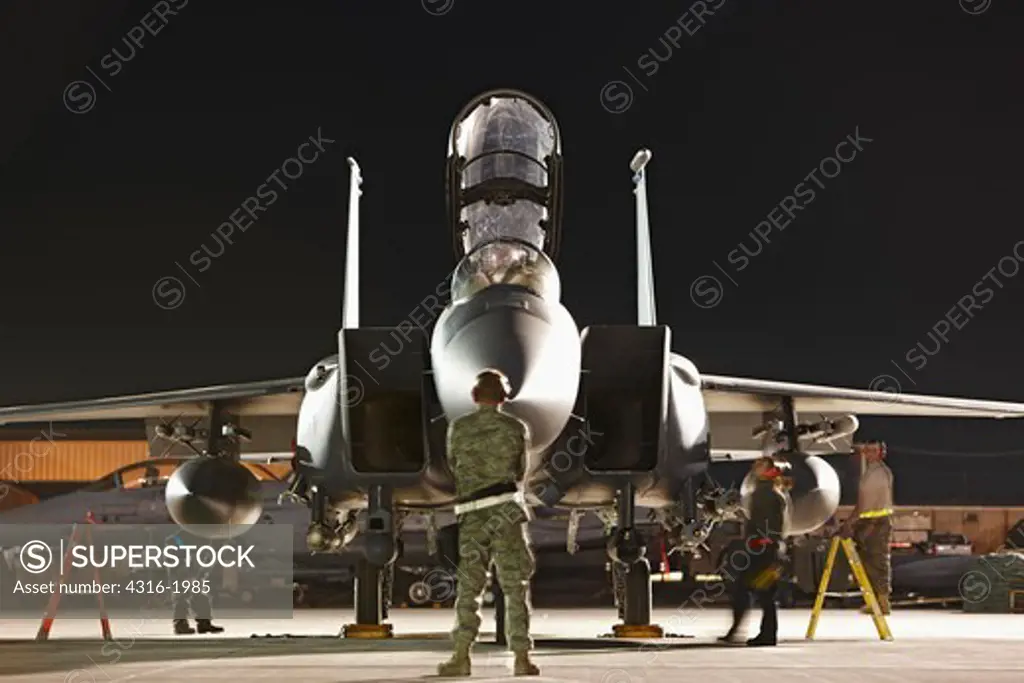 Preparing an F-15E Strike Eagle for a Nighttime Close Air Support Mission