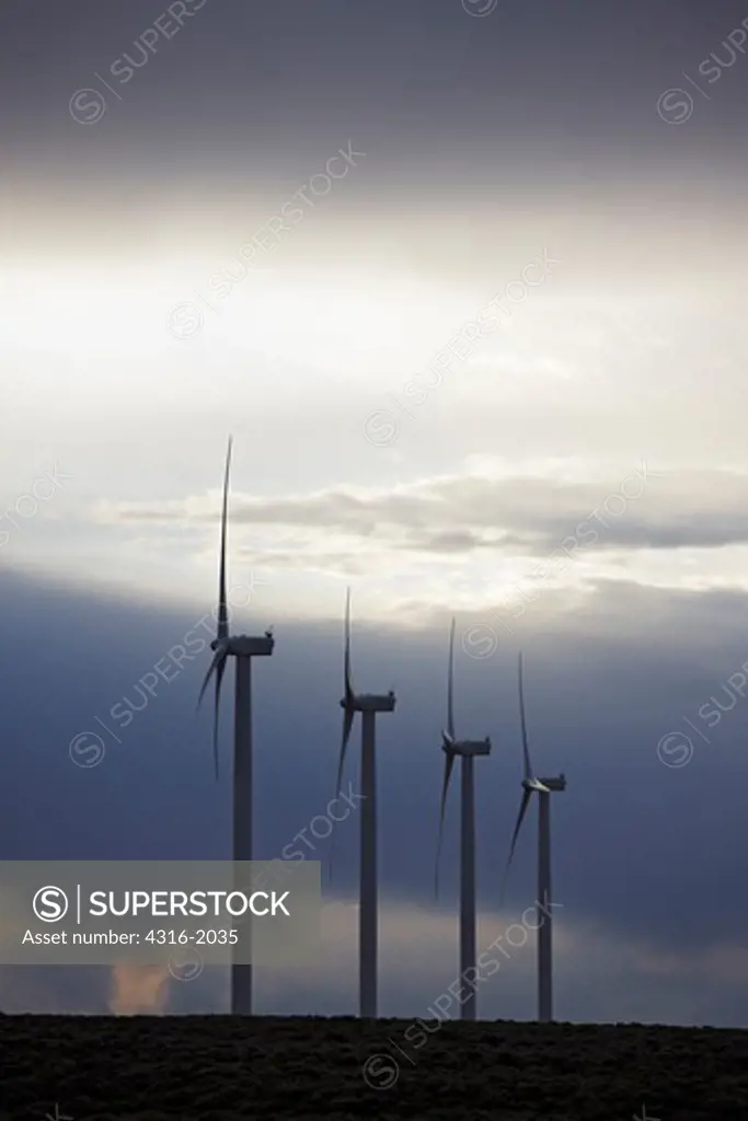 Line of Wind Turbines and Approaching Storm
