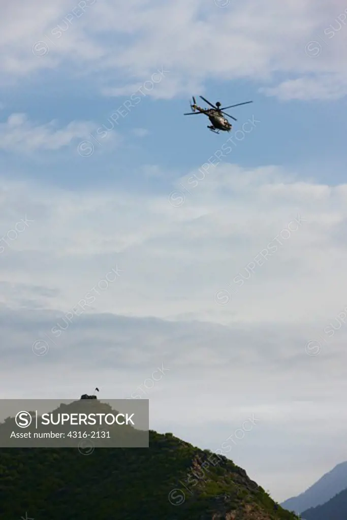 U.S. Army OH-58 Kiowa Warrior Flies Above an Observation Post