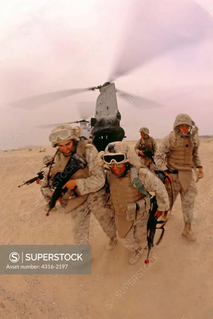 A US Marine is Helped Out of a Helicopter During Medevac Training