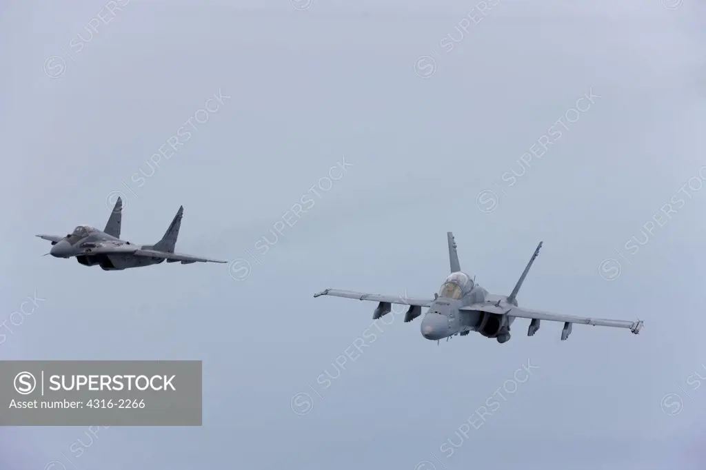 A United States Marine Corps F/A-18D Hornet and a Malaysian Air Force Mig-29 Fulcrum high above the South China Sea, Malaysia.