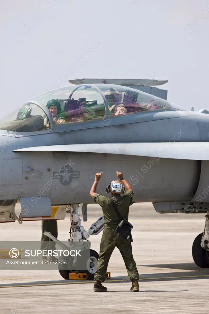 United States Marine Corps aviators prepare to launch an F/A-18D Hornet at Kuantan Air Base, Malaysia.